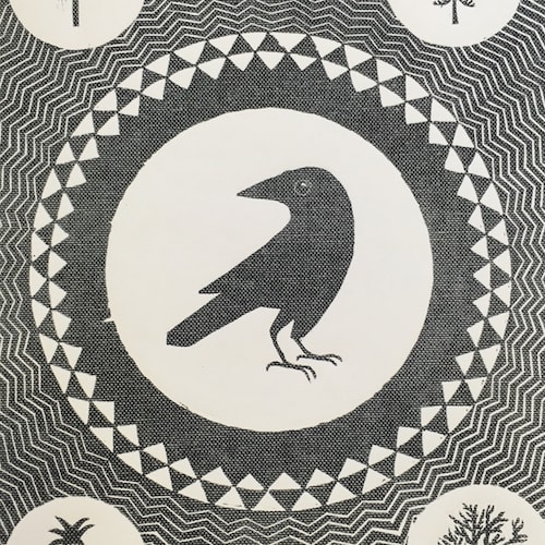 A linocut print of a crow surrounded by patterns